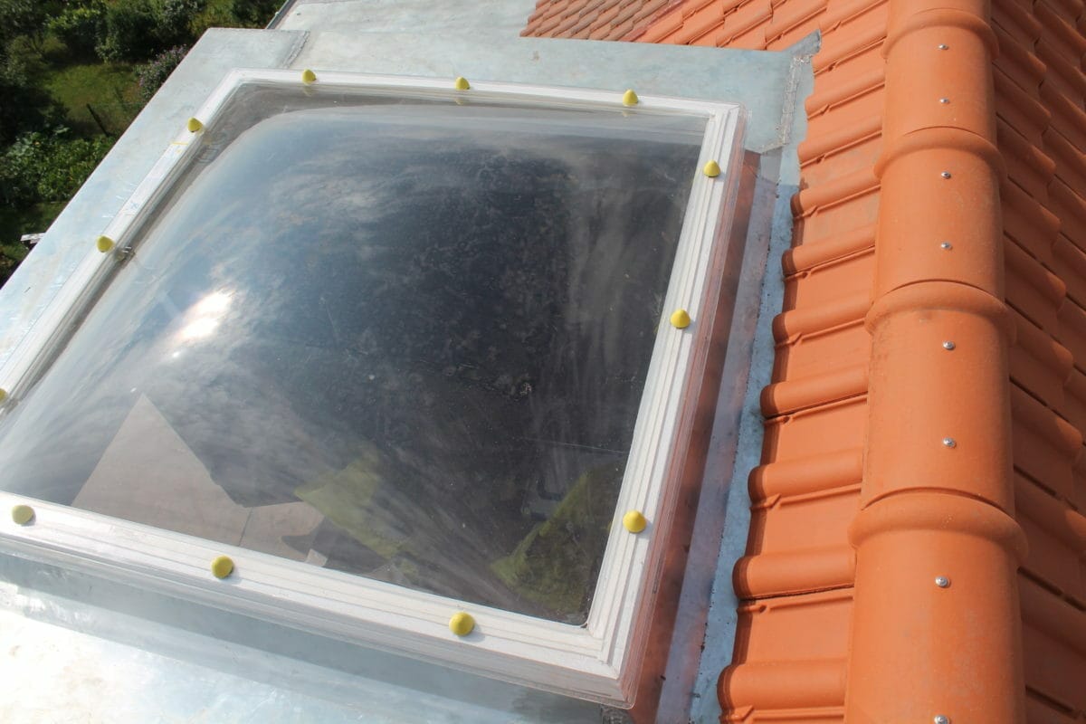 Dome skylight fitted on a tiled roof