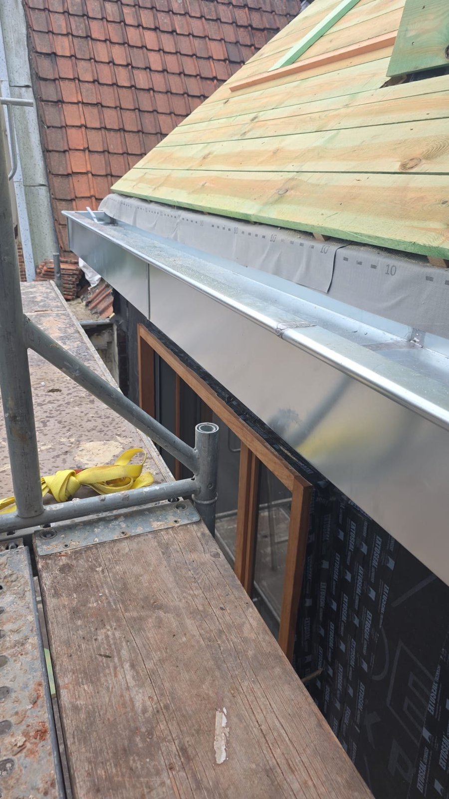 New boarding and zinc gutter being fitted