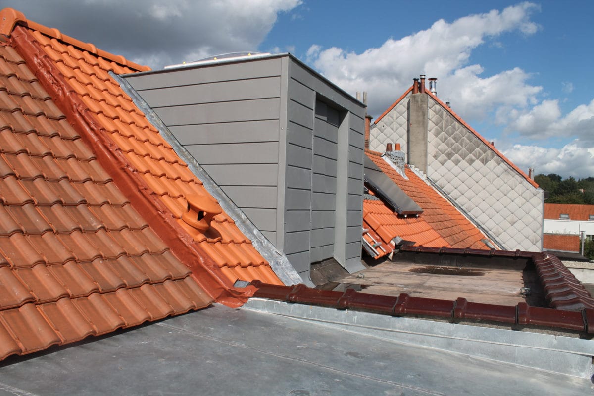 Tiled roof with zinc-clad dormer and flat roof