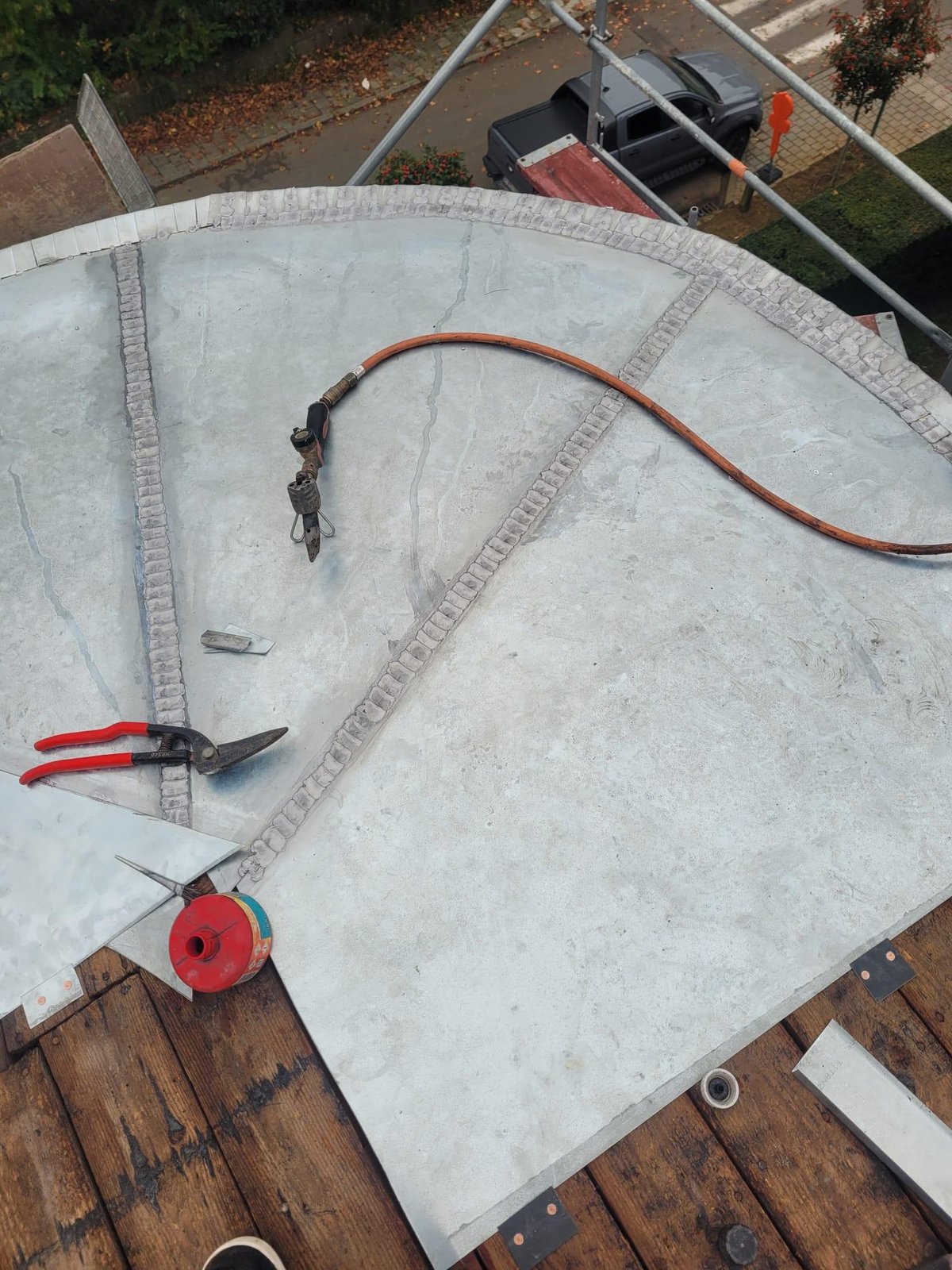 Curved zinc roof being installed